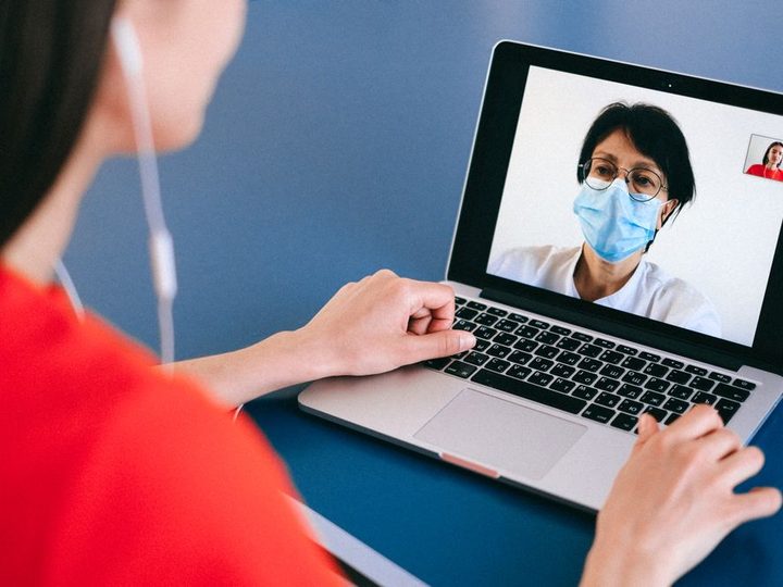 A clinician connecting with a colleague over video