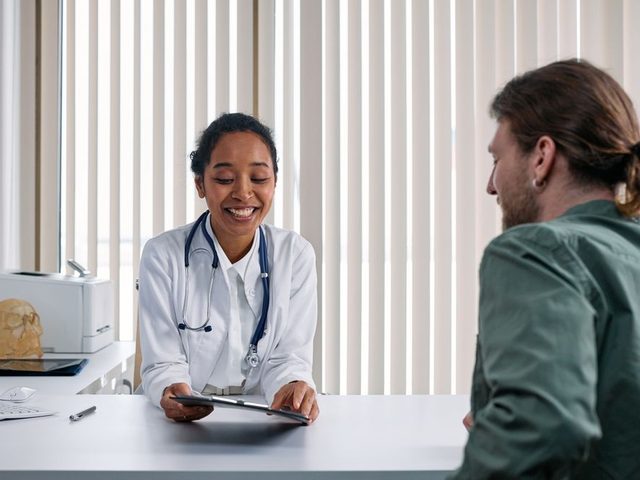 Doctor showing a patient their records on a tablet
